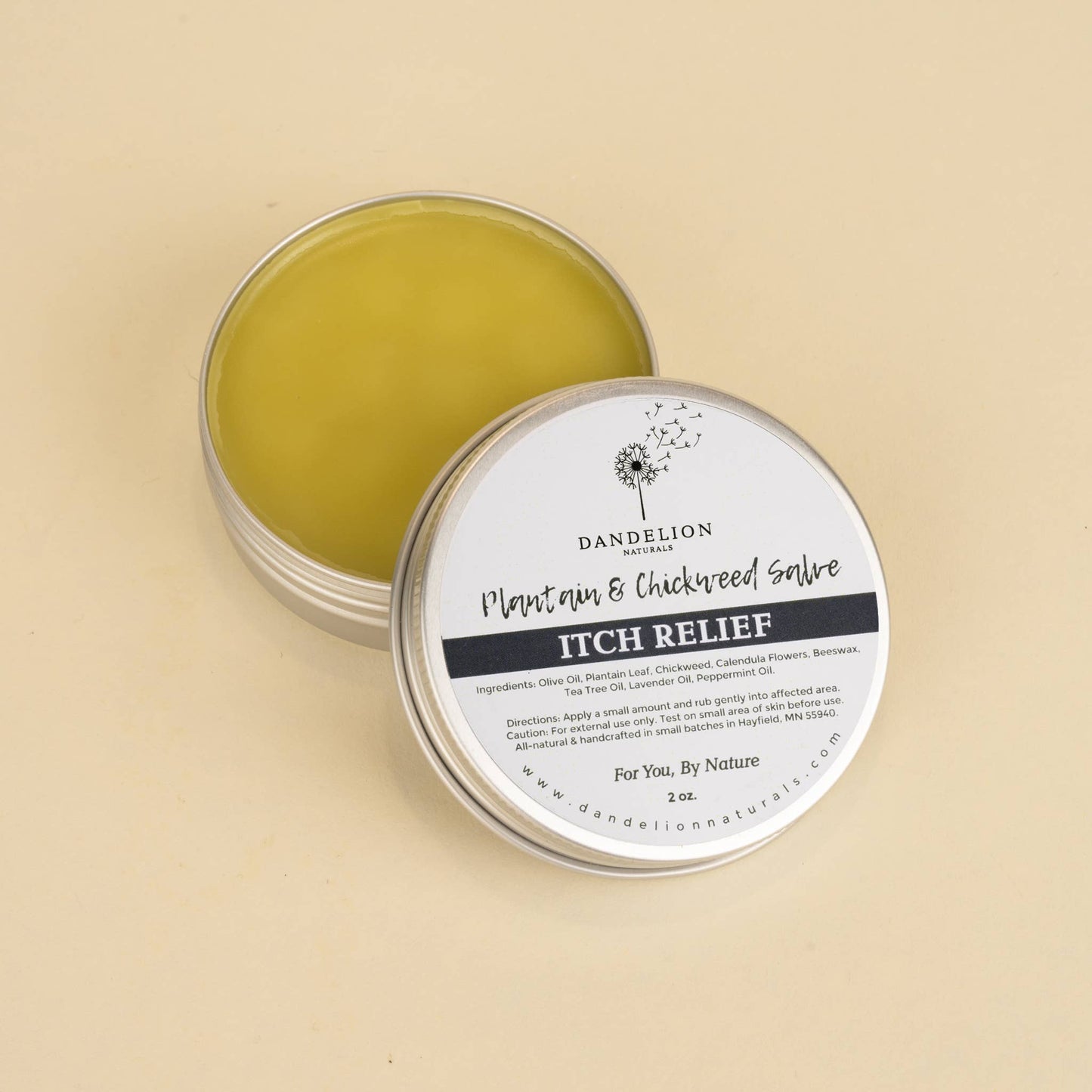 Dandelion Naturals Plantain & Chickweed salve tin with itch relief balm on beige background