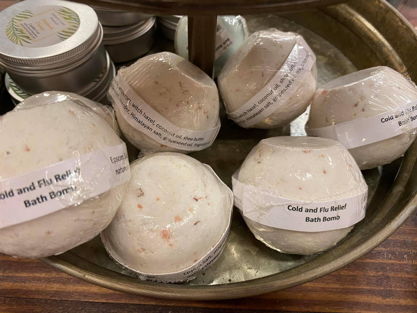 Cold and Flu Relief bath bombs wrapped in plastic on a metal tray, natural remedies from Rooted In Faith Apothecary