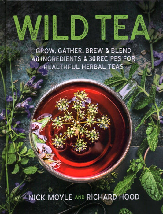 Book cover of Wild Tea featuring a cup of herbal tea with flowers and green herbs on a rustic surface