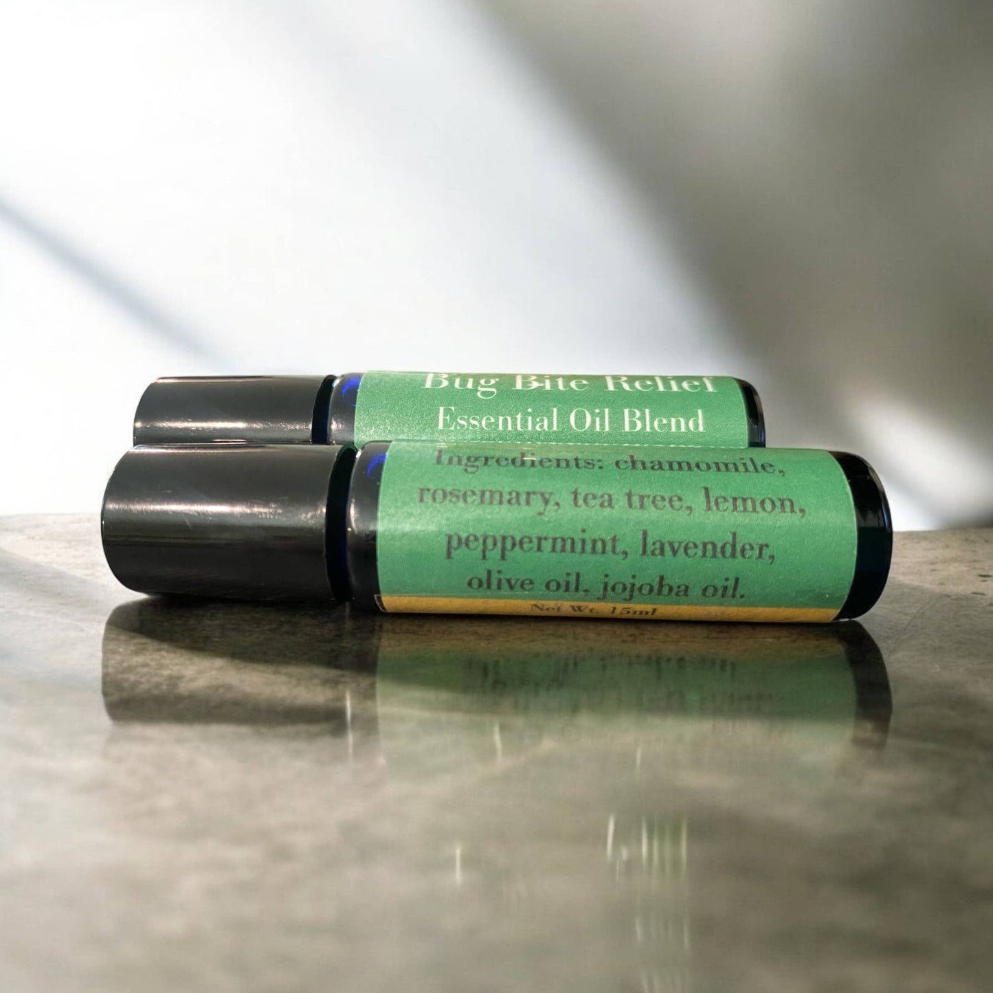 Bug Bite Relief Essential Oil Blend roll-on bottles with chamomile, rosemary, tea tree, lemon, peppermint, lavender oils